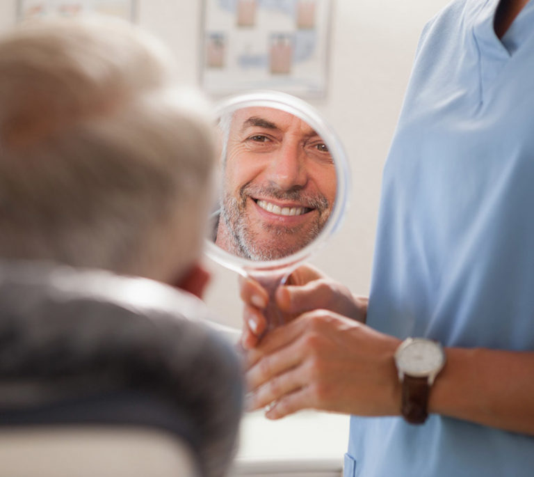 an old man looking at mirror and smiles