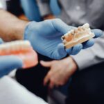 dentist is showing dental implants demo