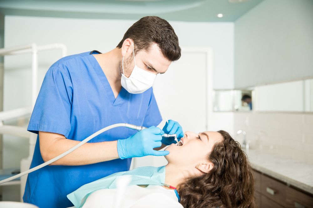 a female is having teeth cleaning treatment
