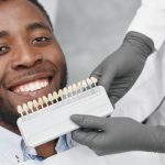 a man is smiling before having dental implant treatment